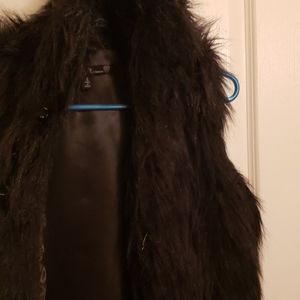 Black faux fur vest.